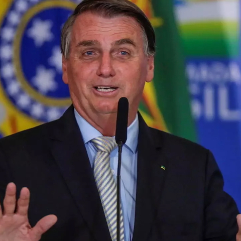 Jair Bolsonaro speaking at microphone