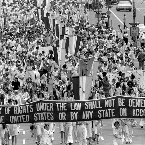 Marchers for the Equal Rights Amount, holding banner that reads "Equality of rights under the law shall not be denied or abridged by the United States or by any state on account of sex"