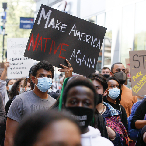 Man at march holding sign that reads "Make America NATIVE Again"