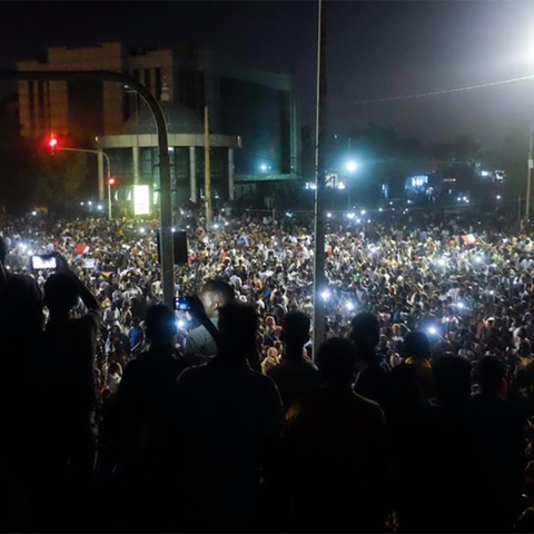 A crowd of protesters at night in Sudan