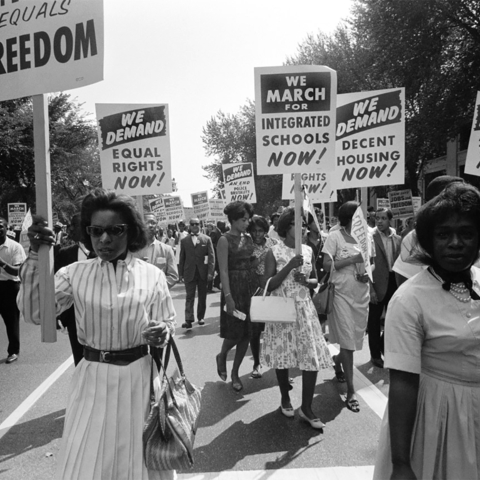 Black women marching with signs supporting integration
