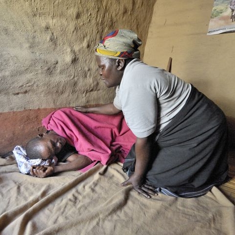 a woman caring for someone with HIV