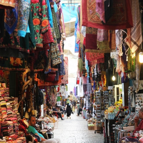 A shopkeeper sits outside his store in the Cardo waiting for tourists and residents to stop in.