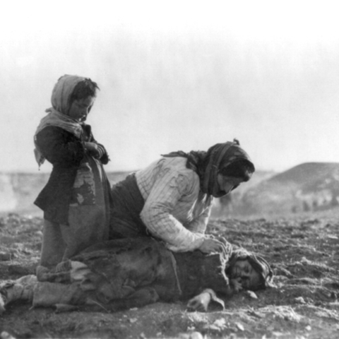 An Armenian woman leans over her dead child near Aleppo, Syria,1915.
