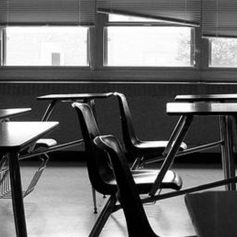 Black and white image of an empty classroom