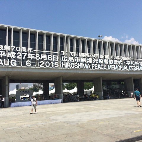 Hiroshima Peace Memorial Museum with a sign announcing the 70th anniversary ceremony.