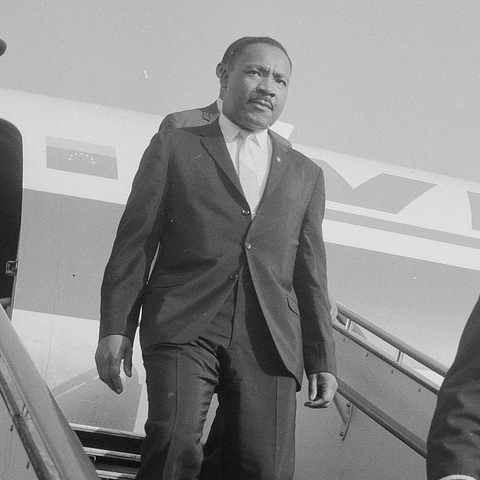Dr. Martin Luther King, Jr. exiting a plane in 1964.