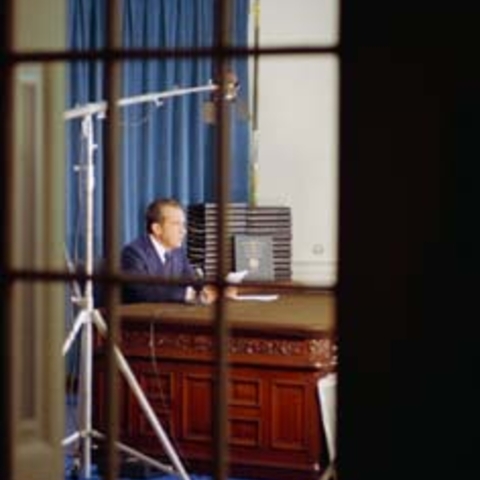 President Nixon photographed through a window explaining release of edited transcripts, April 29, 1974