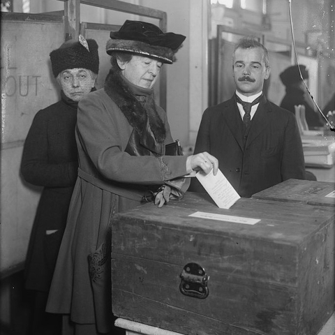 A woman voting in the early 20th century.