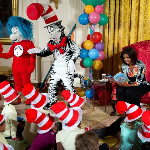 First Lady Michelle Obama reading a Dr. Seuss book to children at the White House.