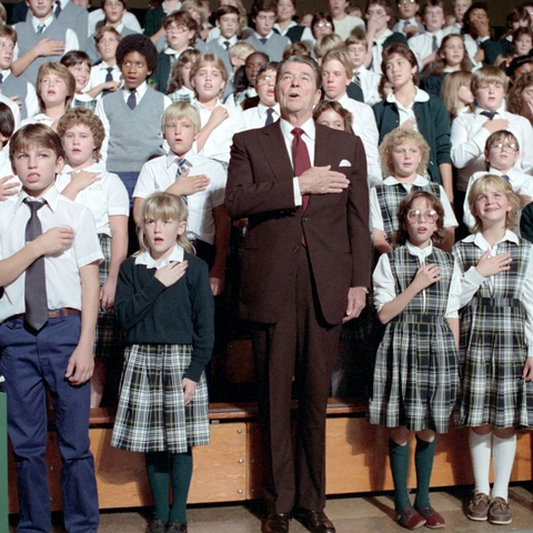 President Reagan recites the Pledge of Allegiance with students from a Detroit Catholic school in 1984.