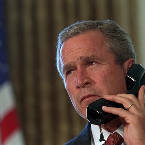 Pledging his support, President George W. Bush talks via telephone to New York Governor George Pataki and New York City Mayor Rudolph Giuliani.