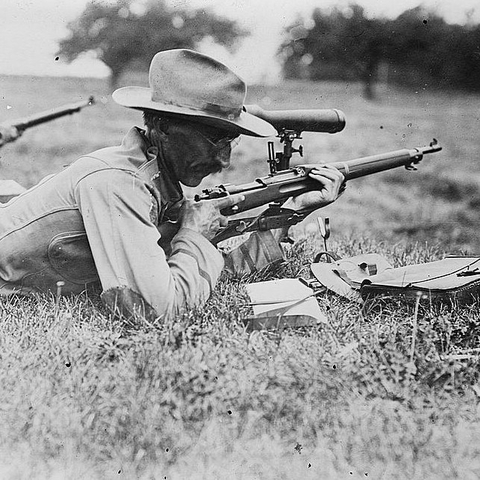 Col C.B. Winders shooting a gun in the 1910s.