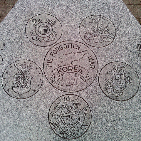 A Memorial to the "Forgotten War" of Korea with the insignias of the United States Uniformed Services ringed around it.