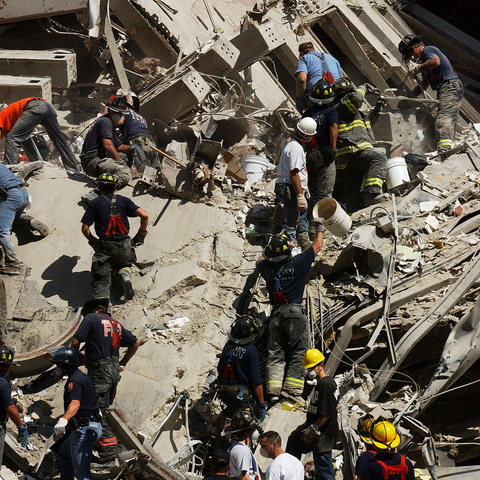 A "bucket brigade" works to clear rubble and debris on September 14, 2001.