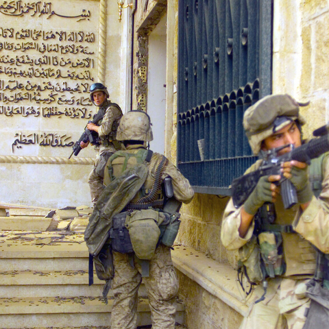 Marines from 1st Battalion 7th Marines enter a palace during the Battle of Baghdad.