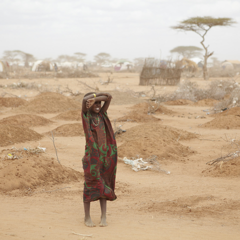 A girl stands amid the graves of 70 children on the outskirts of Dadaab. The long desert journey to the relief camps has claimed many lives.