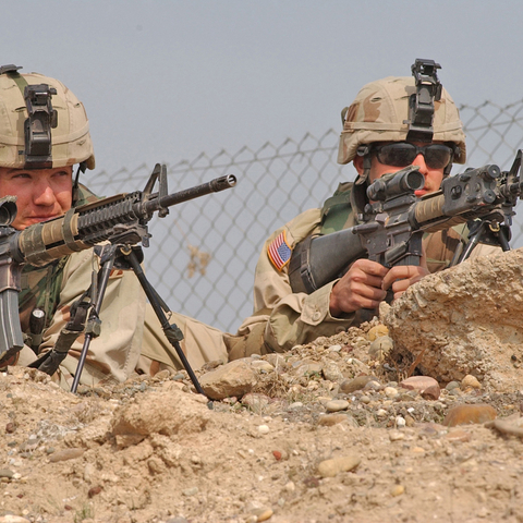 Soldiers from 3rd Infantry Division provide perimeter security for Iraqi policemen at a traffic control point in Tikrit, Iraq.