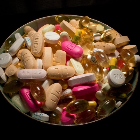 bowl of pills with a black background