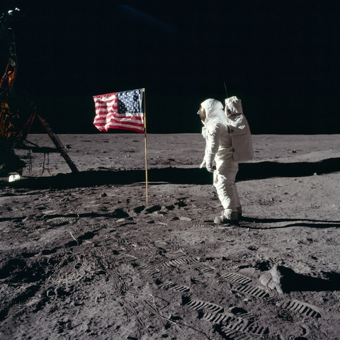 Astronaut Buzz Aldrin salutes United States Flag while standing on the moon 