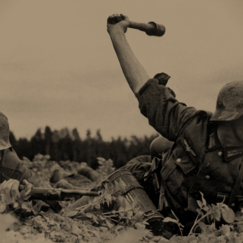 two German soldiers crouching down, one has his hand in the air holding an explosive device and the other is aiming a gun