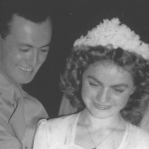 a couple in a wedding dress and soldier dress uniform