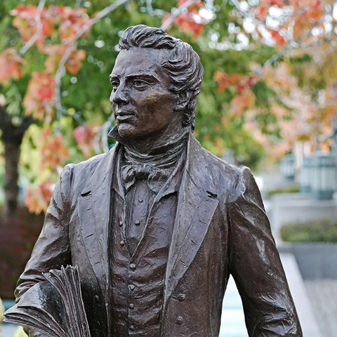 statue of Joseph Smith in a garden