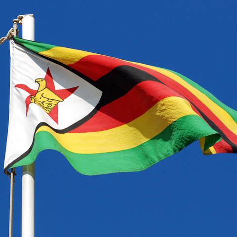 Zimbabwe Flag against a blue sky