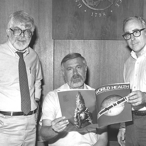 Three former directors of the Global Smallpox Eradication Programme read the news that smallpox had been globally eradicated, 1980.