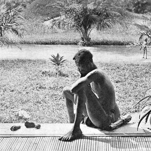 A Congolese man, Nsala, looking at the severed hand and foot of his five-year-old daughter who was killed, cooked, and cannibalized by members of the Force Publique in 1904.