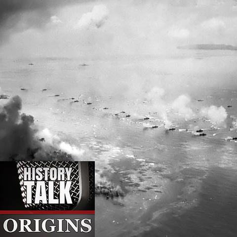 Black and white aerial photo of U.S. Marine boats approaching shore as smoke fills the air during the invasion of Peleliu