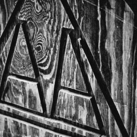 Black and white photo of the Alcoholics Anonymous logo carved into a wooden plaque