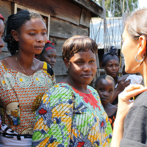 Congolese women speaking with the International Rescue Committee’s gender-based violence program coordinator.