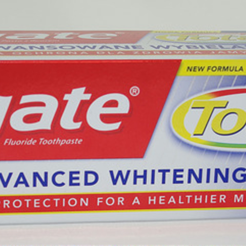 Colgate, like most American toothpastes, indicates the presence of fluoride by including it as part of the name.