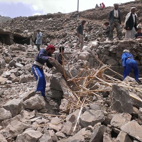 Villagers in Hajar Aukaish, Yemen searching rubble after a bombing in 2015.