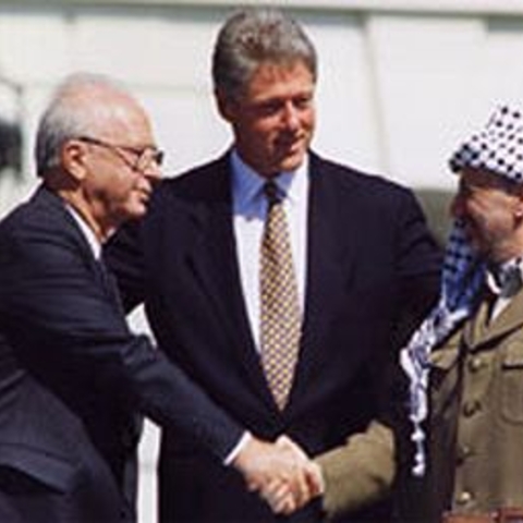 Israeli Prime Minister Yitzhak Rabin, PLO Leader Yasser Arafat, and U.S. President Bill Clinton signing the Oslo Accords in 1993