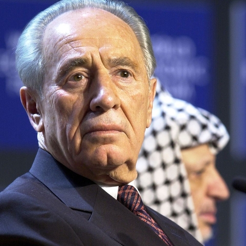 Shimon Peres with Yasser Arafat in the background at the World Economic Forum in Davos, Switzerland on January 28, 2001