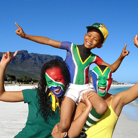 Soccer fans, painted in the colors of South Africa's flag, celebrate the coming of the 2010 FIFA World Cup to South Africa.