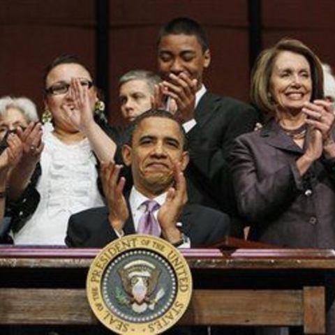 President Barack Obama signing the Healthcare Bill with the new student loan provisions. Secretary of Education Arne Duncan and Speaker Nancy Pelosi join him, March 2010