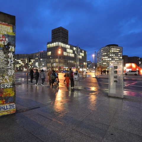 Remnants of the Berlin Wall in Potsdamer Platz, 2009. The white paint in the upper corner reads "At this place, the first hole in the Berlin Wall was created."  