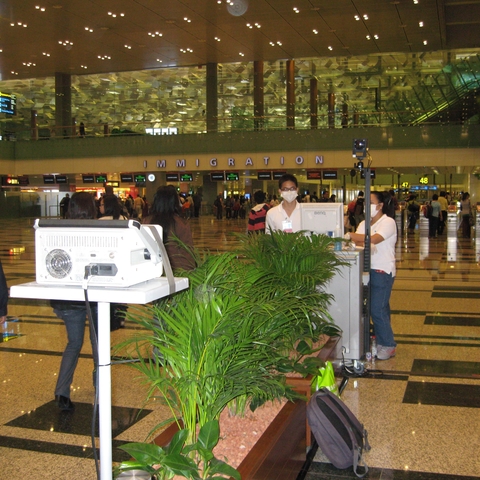 The arrivals area at Singapore International Airport, using thermoscanning to look for travelers with a fever who may be infected with swine flu, June 2009