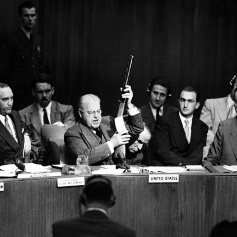 The U.S. delegate to the UN holding a Soviet-made gun.