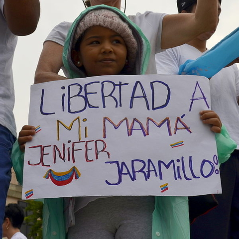 A child protestor asking for freedom for her mother, a political prisoner.