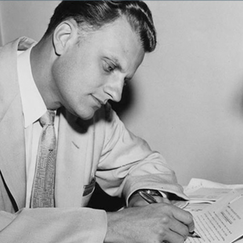 Billy Graham writing his column, 'My Answer.'