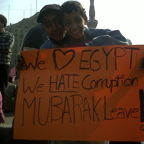 Children holding a sign criticizing then Egyptian President Hosni Mubarak in February 2011, days before he was removed from office