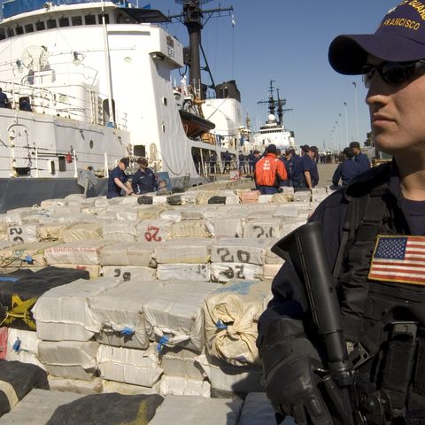 A U.S. Coast Guard sailor stands guard over more than 40,000 pounds of Latin American cocaine seized in 2007 and valued at around $500 million.