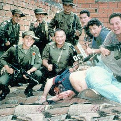 Colombian soldiers pose with the body of Pablo Escobar, the most infamous member of the Medellín cartel, who was killed in 1993