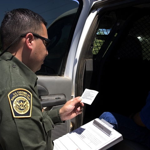 A U.S. Border Patrol agent reads Miranda rights to a Mexican national arrested for transporting drugs