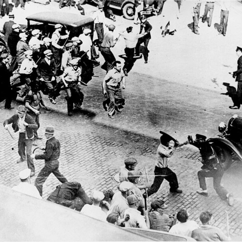 Open battle between striking teamsters armed with pipes and the police in the streets of Minneapolis, June 1934