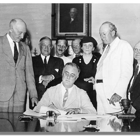 FDR signs the Social Security Act in 1935. His opponents called his policies socialist.